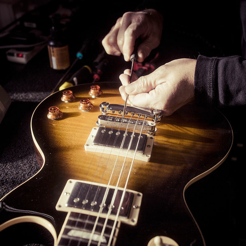 technician setting up a guitar in the guitar studio workshop
